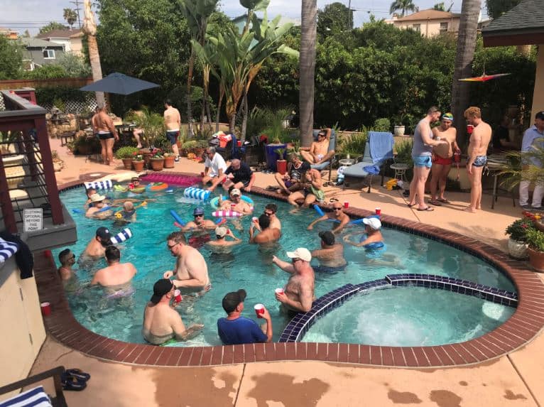Many men gathering around and in a pool